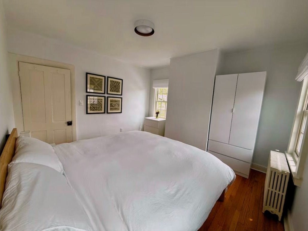 Primary bedroom with king bed and white wardrobe
