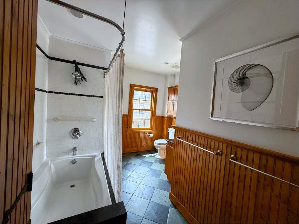 Bathroom with clawfoot-style tub and shower curtain